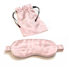 A light pink Mulberry Silk Sleep Eye Mask with silk covered elastic strap is shown below a matching satin drawstring pouch on a white background.