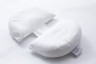 The Side Sleeping Chest Pillow, a butterfly-shaped white pillow with a curved center gap and fabric strip, is shown on a white background. A logo tag accents one side, making it ideal for post-surgery breast support.