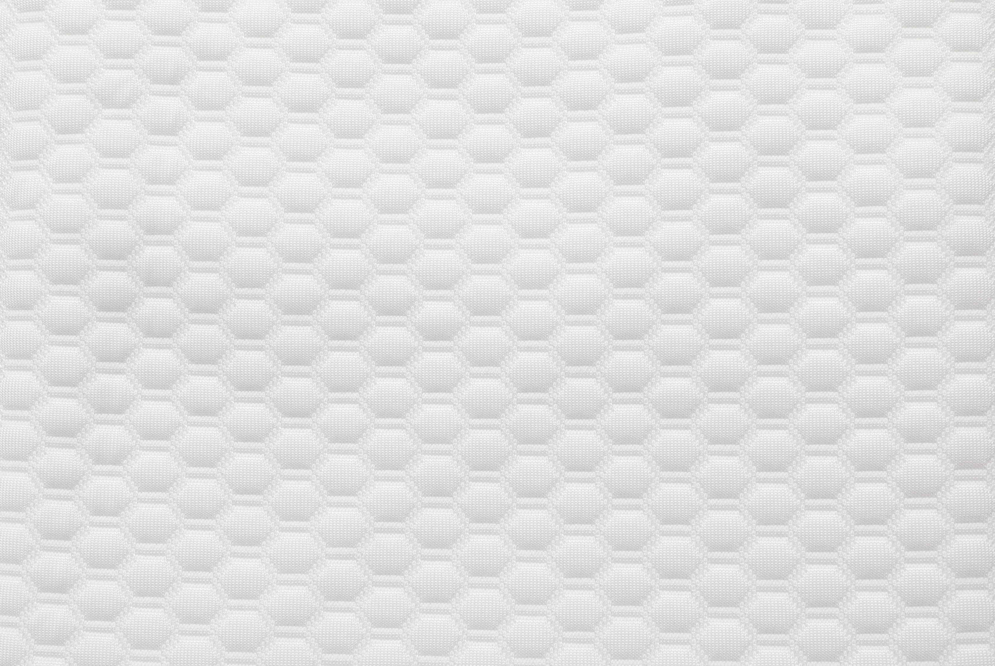 The Cooling Fitted Sheet for the Sleep Again Pillow System features a hexagonal honeycomb pattern with a subtle 3D effect on white, providing a textured, geometric look—perfect for hot sleepers or pairing with your pillow system.