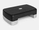 A black and gray rectangular Bedside Step Stool with a textured, non-slip surface and short legs, this versatile step platform is ideal for fitness exercises.