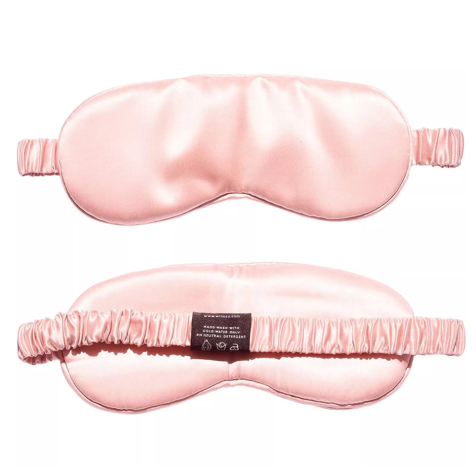 Two light pink Mulberry Silk Sleep Eye Masks are displayed—one shows the smooth front, the other highlights the silk-covered elastic strap and care label, emphasizing the mask’s elegant design and luxurious material.