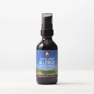 A 2 fl oz (59 ml) dark glass spray bottle of Kick-Ass Allergy, Seasonal Rescue stands on a light surface with a plain white background, offering natural allergy relief.