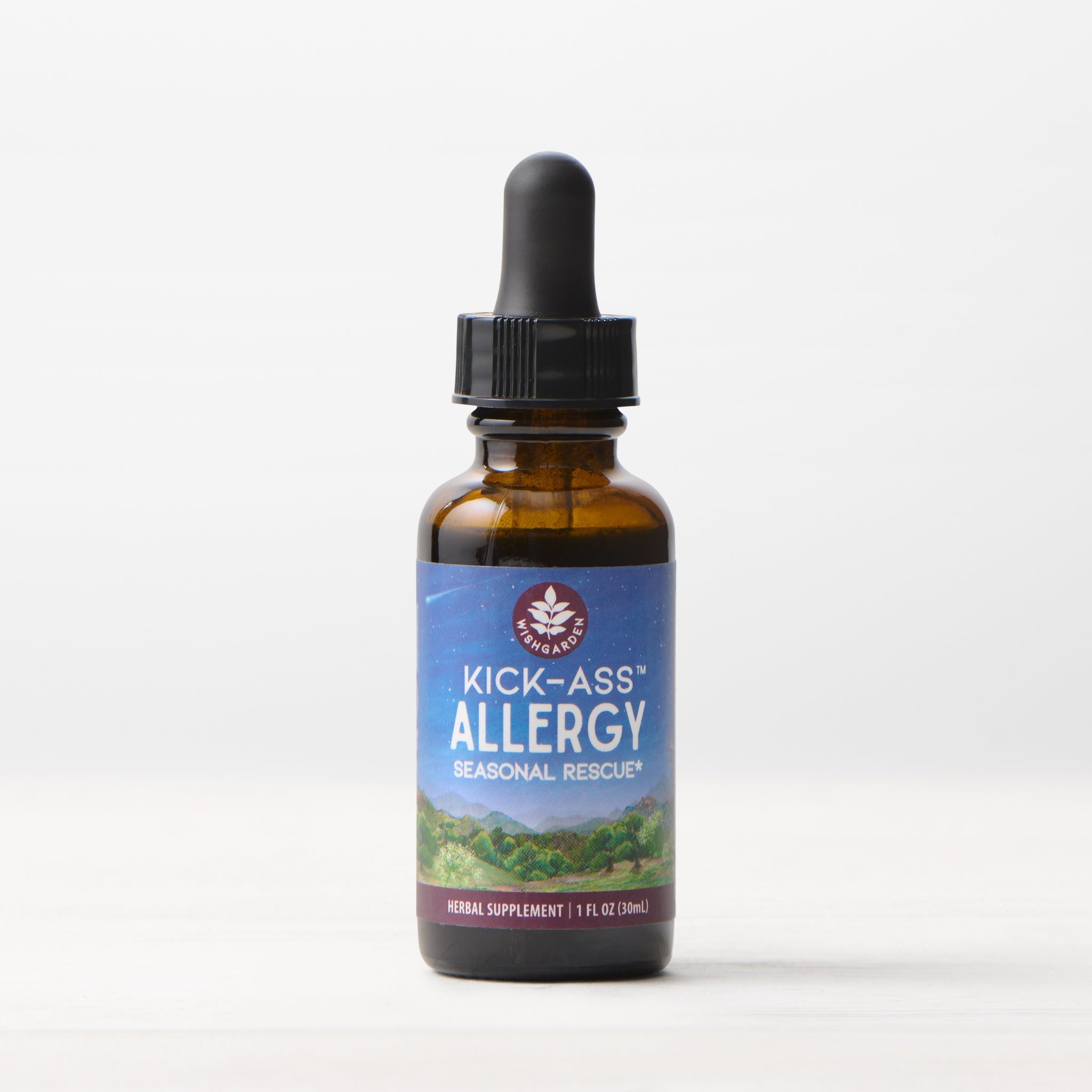 A brown glass dropper bottle labeled “Kick-Ass Allergy, Seasonal Rescue” herbal supplement, 1 fl oz (30 ml), with a blue label featuring mountains, stands on a light surface against a white background.