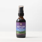 A small brown bottle with a black pump cap, labeled "Hot Flash Tamer, Daily Regulator," features a mountain landscape and purple accents. Shown on a plain white background, this herbal supplement supports natural menopause relief.