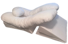 The BBL Add On Set includes a white U-shaped body pillow with an attached cylindrical neck pillow, placed atop two wedge-shaped cushions. All pieces are covered in soft white fabric—ideal for BBL recovery.
