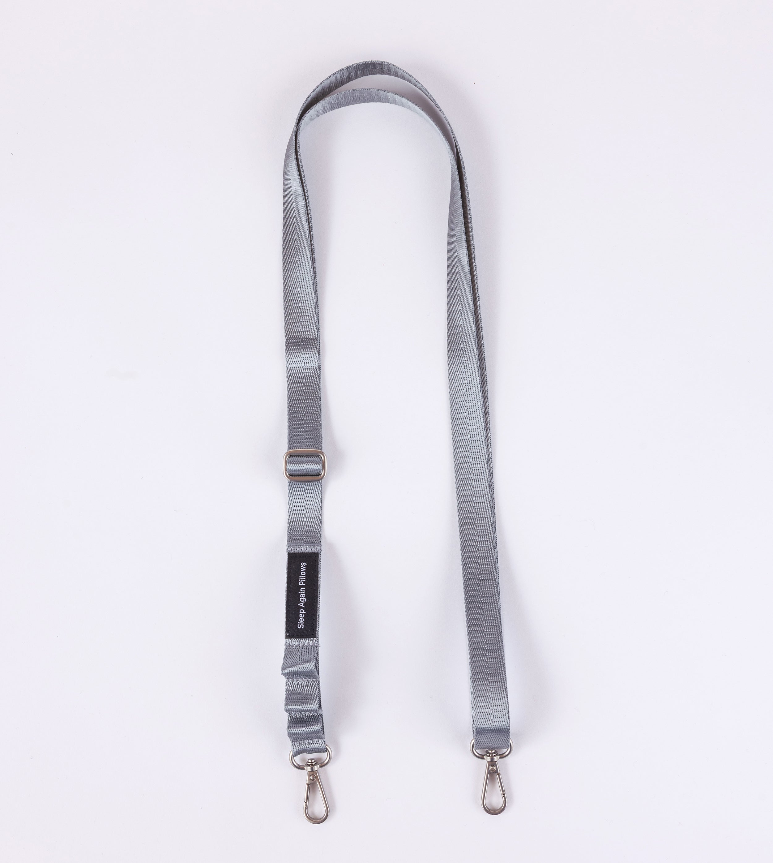 The Sleep Again Surgical Drain Holder is a gray adjustable lanyard with two metal swivel clasp hooks, designed for post-operative drain management and shown laid flat on a white background.