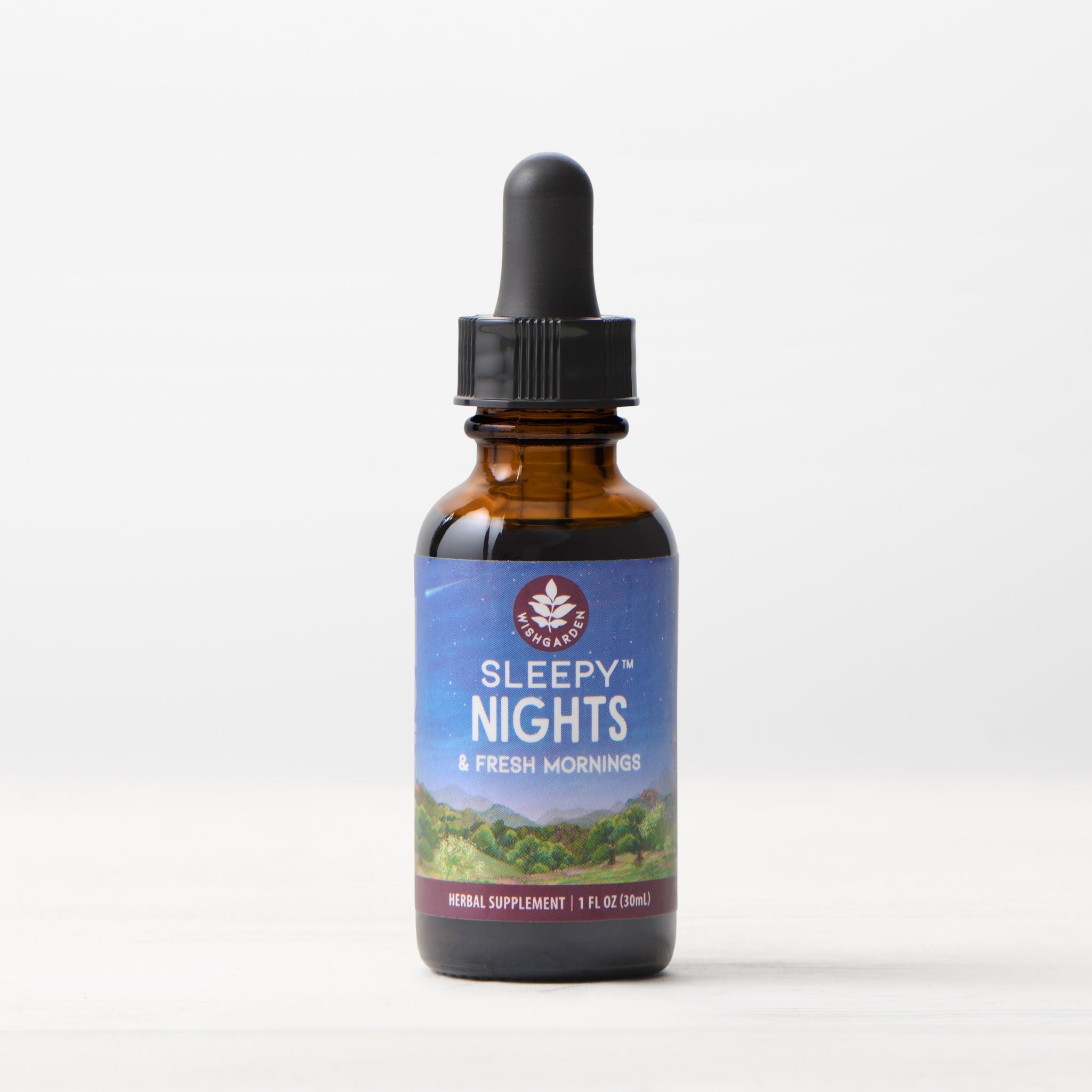 A brown glass dropper bottle labeled Sleepy Nights & Fresh Mornings, 1 fl oz (30ml), sits on a pale background—an organic sleep supplement crafted with gentle herbs for restful nights without sedation.