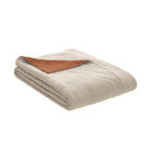 The PureCare Duvet Cover | Cooling Bamboo is shown neatly folded in beige with a corner flipped to reveal its brown underside, all set against a plain white background.